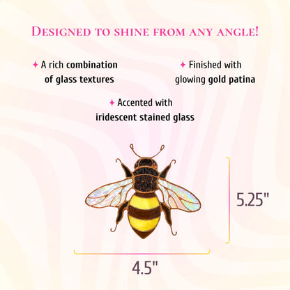 Mini bee stained glass suncatcher, 4.5 inches wide and 5.25 inches tall. Text: designed to shine from any angle. A rich combination of glass textures, finished with glowing gold patina and accented with iridescent stained glass.