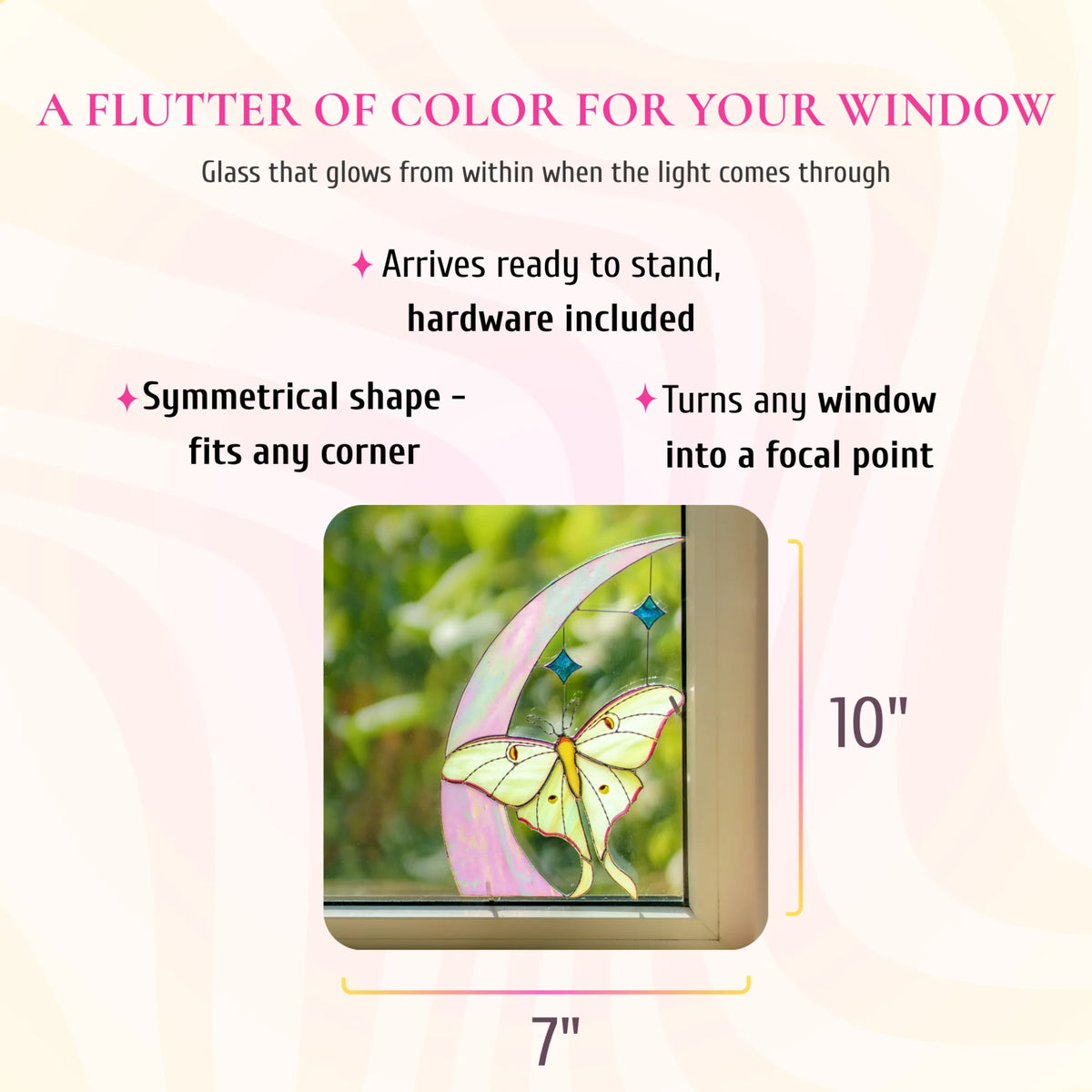 Luna moth and crescent moon stained glass window corner, 7 inches wide and 10 inches tall, shown in a window corner. Text: a flutter of color for your window, glass that glows from within when the light comes through. Arrives ready to stand with hardware included, its symmetrical shape fits any corner and turns any window into a focal point.