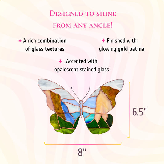 This delicate stained glass butterfly is accented with opalescent glass, gold patina, and measures 8 inches wide by 6.5 inches high.