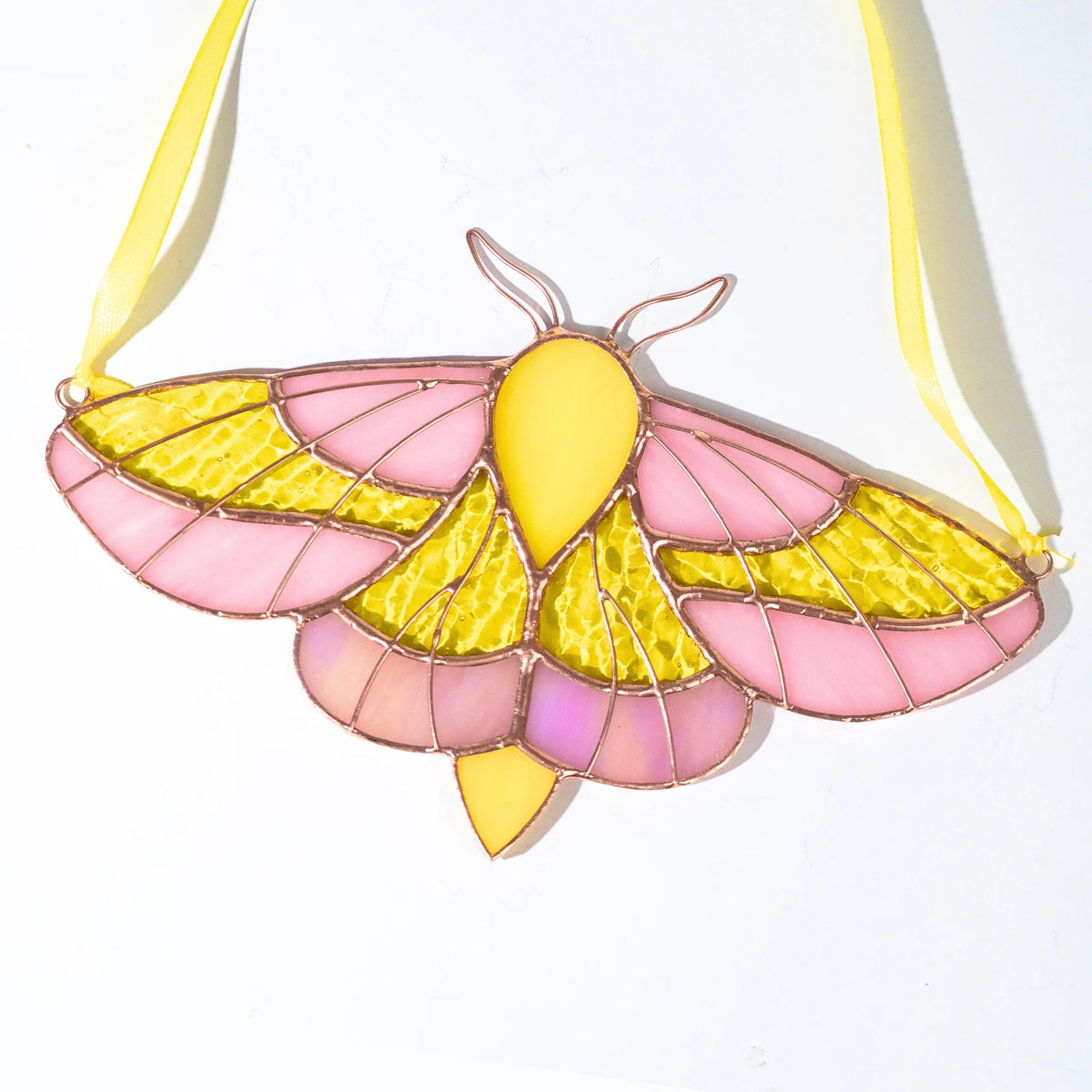 Stained glass luna moth suncatcher with yellow ribbon and iridescnt details