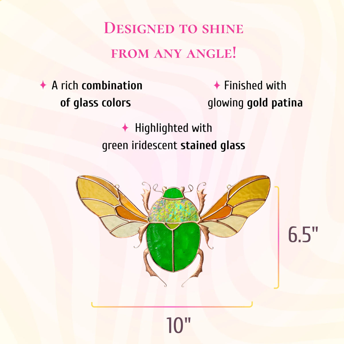 A decorative glass beetle ornament with a bright green body, gold-toned wings, and pink legs, shown on a pale pink background with size measurements of 10 inches by 6.5 inches.