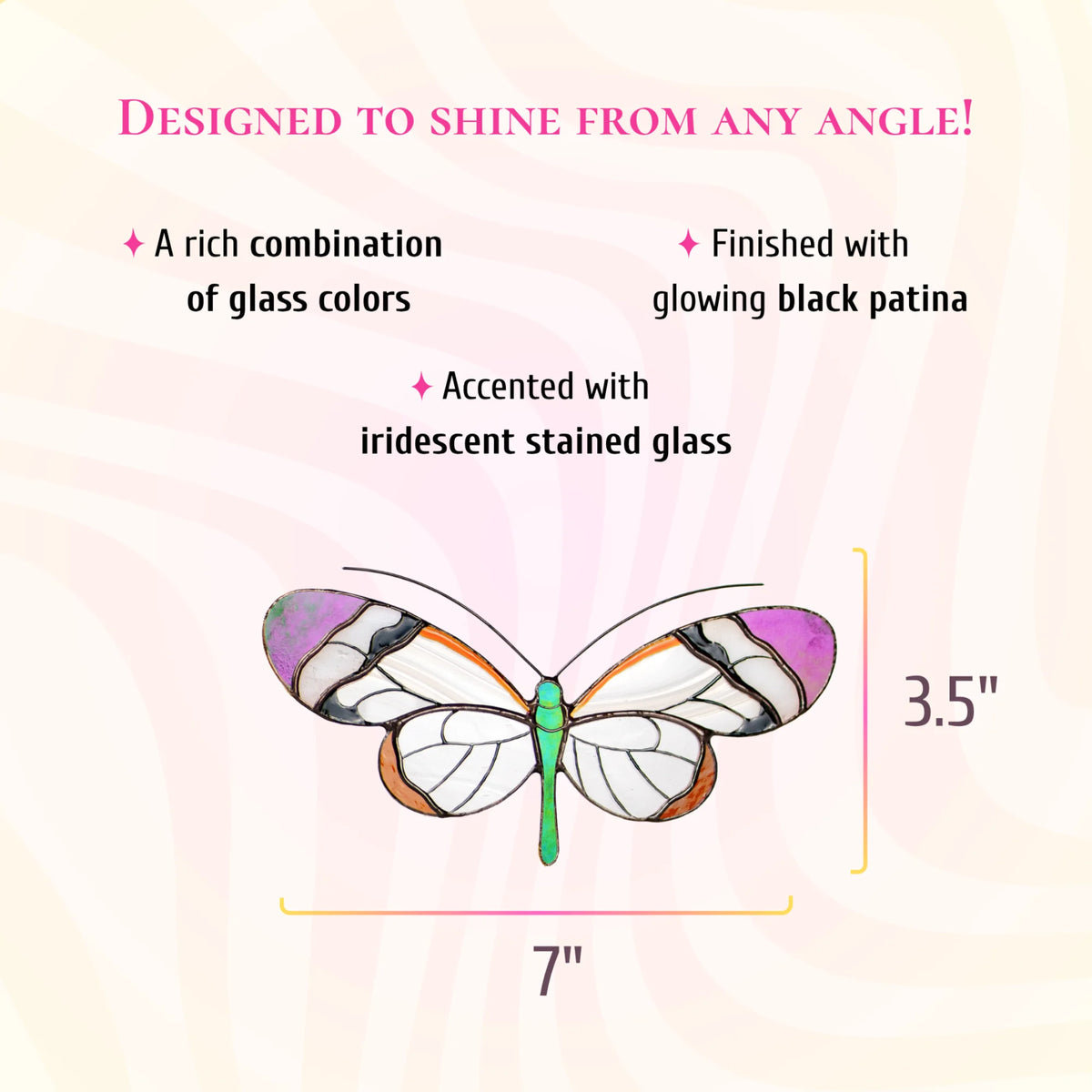 Glasswing butterfly stained glass suncatcher with clear white wings, violet tips and a green body, 7 inches wide and 3.5 inches tall. Text: designed to shine from any angle. A rich combination of glass colors, finished with glowing black patina and accented with iridescent stained glass.