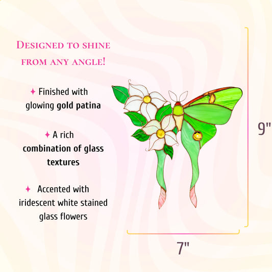 A decorative stained-glass style butterfly ornament with green wings, white flowers, and gold accents, with dimension markers 7 inches wide by 9 inches tall.