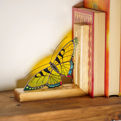 This detailed yellow stained glass butterfly bookend supports books on a shelf, highlighting its appeal as a memorable home decor gift.