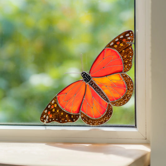 Close view of the monarch window corner, fiery orange glass and amber wing borders with white dots