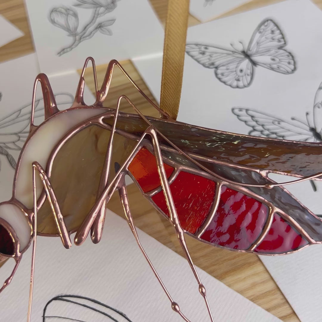 A charming video highlighting a unique stained glass mosquito, focusing on its exquisite artistry and ability to add a touch of magic to your favorite space.