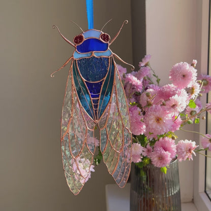 A dynamic video presentation of a versatile stained glass blue cicada suncatcher, showcasing its exceptional craftsmanship and charm as a perfect home decor accent.