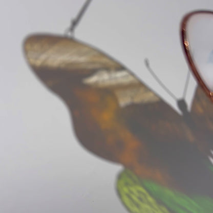 A lovely video highlighting a handcrafted stained glass butterfly with Yosemite landscape, capturing how it beautifully enhances any shelf or space with its artistic design.