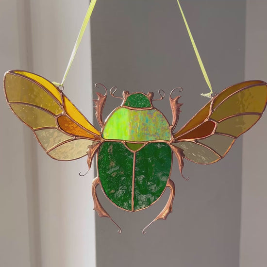 A captivating video showcasing the stunning details and vibrant colors of a handmade stained glass green scarab, highlighting its beauty as a unique and memorable gift