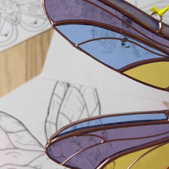 A delightful video showcasing a handcrafted stained glass dragonfly, capturing its radiant colors and fine craftsmanship as a wonderful gift for any occasion.